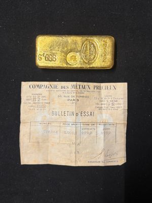 a piece of paper with a gold bar on top of it