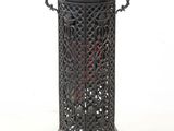 a small black candle holder on a white background