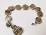 a bracelet made of shells and a key on a table