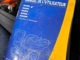 a book on the seat of a car with a remote control