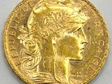 a close up of a gold coin with a woman ' s head on it
