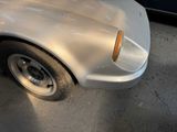 a car that has been dented and is parked on the side of the road