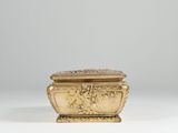 an image of a gold box sitting on top of a white table