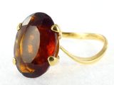 a picture of a ring with a large brown stone