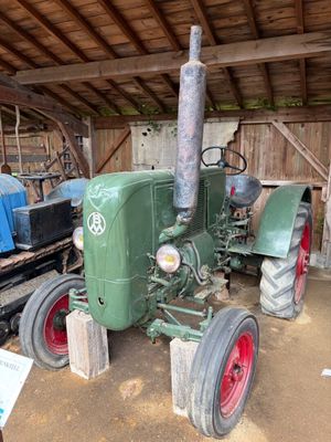 un tracteur vert garé dans une grange
