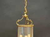 an antique brass and glass lantern hanging from a chain