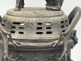 a statue of a dog on top of a vase