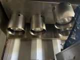 three pots that are hanging from the ceiling in the kitchen
