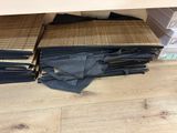 a lot of folded up black pants on the floor