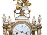 a white and gold clock with birds on it