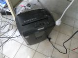 an image of a black and white paper shredder on a tiled floor