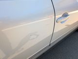 a close up of a car door handle with a shadow on the door