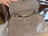 a person holding a purse that is sitting on a table