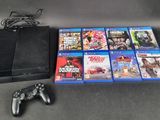 a lot of video games and a game controller on the table