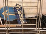 a metal rack with a sign and a skateboard on it