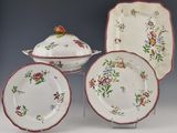 three plates and a bowl with a lid are sitting next to each other