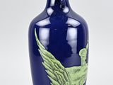 a blue vase with a green bird on it
