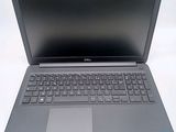 the dell laptop is open and ready to be used on the desk