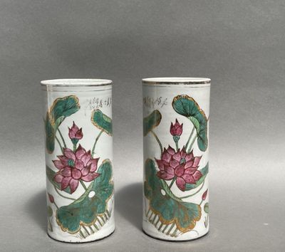 pair of chinese vases with lotuses and leaves on them