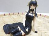 a figurine of a woman sitting on the floor