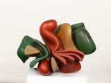 a sculpture of a flower made of wood on a white pedestal