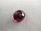 a close up of a pink diamond on a white surface