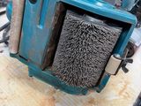 a blue machine that has a brush in it