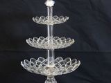 an image of a glass cake stand on a black background