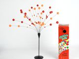 un petit arbre qui se trouve à côté d'une boîte de bonbons