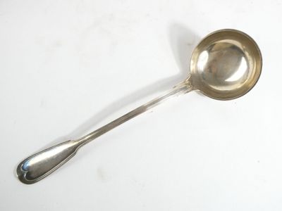 a silver spoon with a spoon handle on a white surface