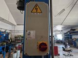 a picture of a machine in a workshop with a sign on it