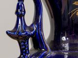 a blue vase with gold and blue designs on it