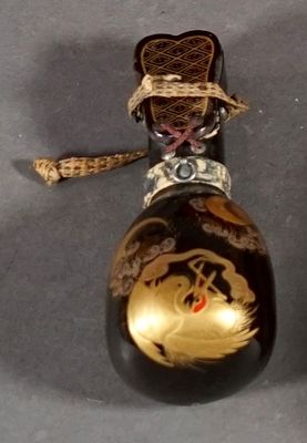 a black and gold bottle with a gold dragon on it