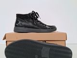 a pair of black shoes sitting on top of a box