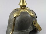 an old fashioned helmet with a gold spike on the top of it