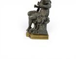 bronze statue of a man playing a flute on a wooden base