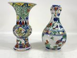 two vases sitting next to each other on a table