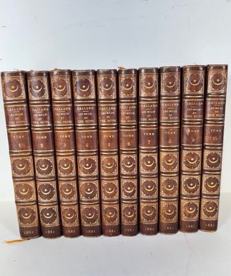 a set of six old books with brown covers on a white surface