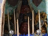 a small shrine with candles and a statue of the virgin mary