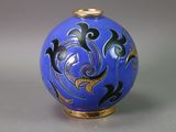 a blue vase with black and gold designs on it