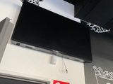 a flat screen tv mounted on the wall above a door