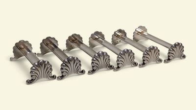 six silver metal door handles on a white background