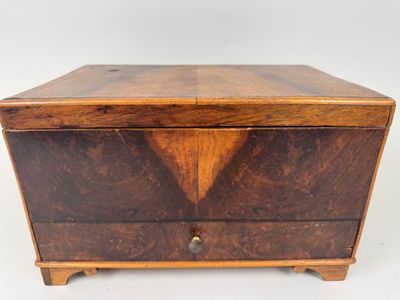 an old wooden box with two drawers on top of it