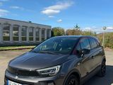 a grey car parked in a parking lot next to a building