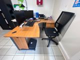 a desk with a chair and a computer on it
