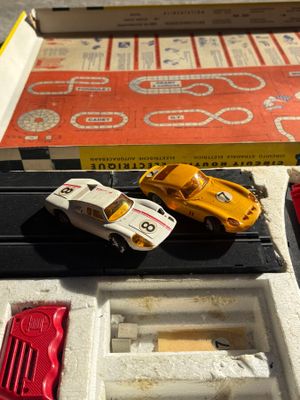 two toy cars that are sitting in a box