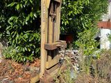 a wooden chair sitting in the middle of a yard