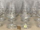 several empty wine glasses are lined up on a wooden table