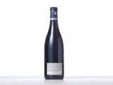 a bottle of wine sitting on top of a white table