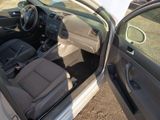 the interior of a car with the door open and the driver ' s seat down